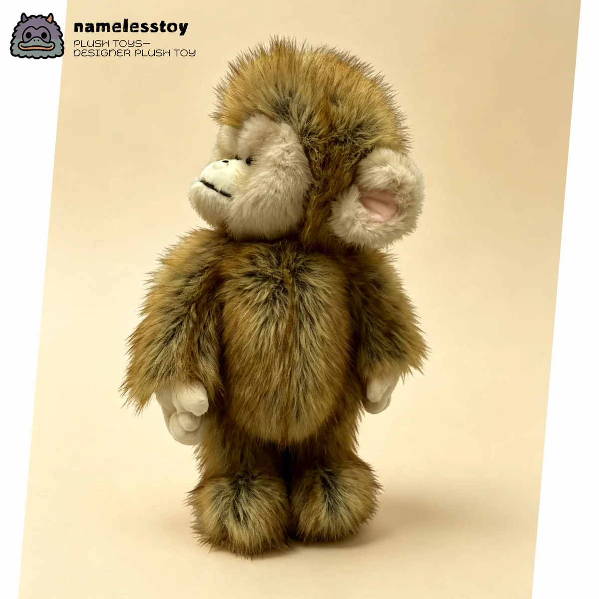 Side profile of the macaque plush showing layered fur across the back